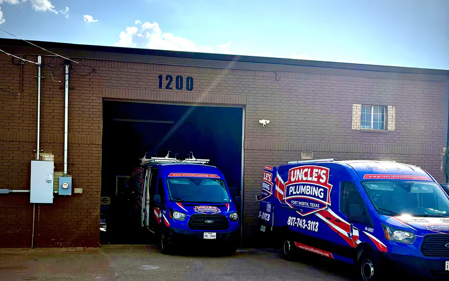 Uncle's Plumbing shop at 1200 E Kennedale Parkway, with two branded vans at the open bay door