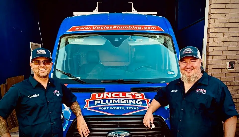 Uncle's Plumbing crew standing in front of a branded service van